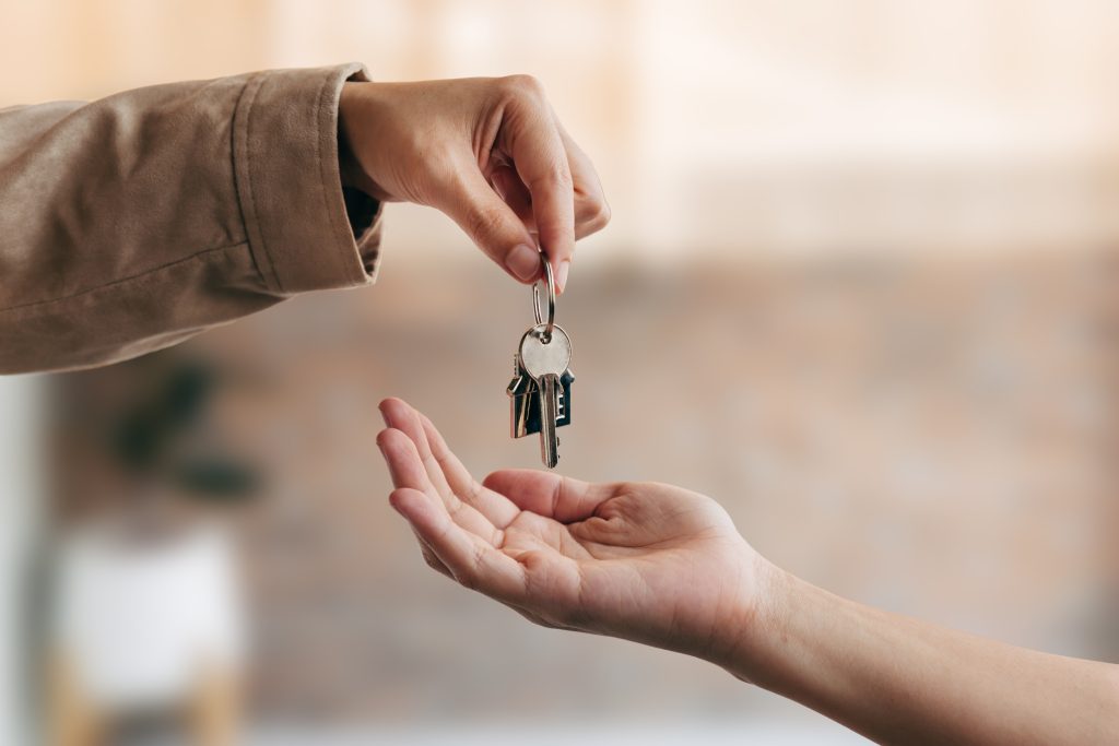 Landlord and tenant exchanging keys